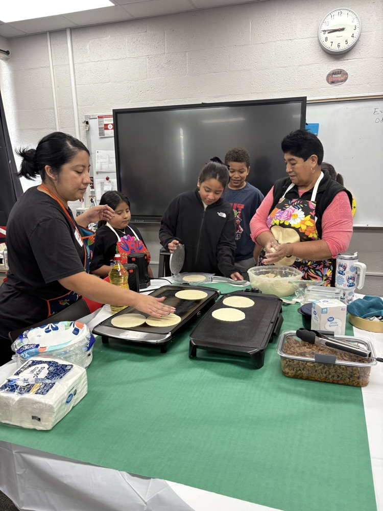 students helping make tortillas