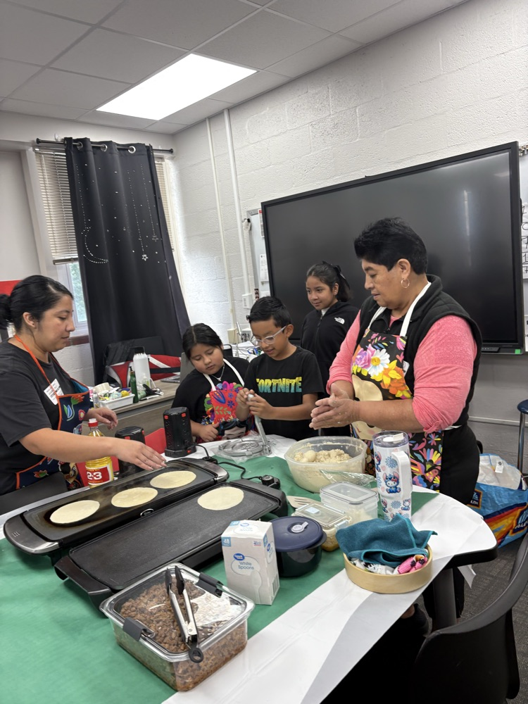 students helping make tortillas
