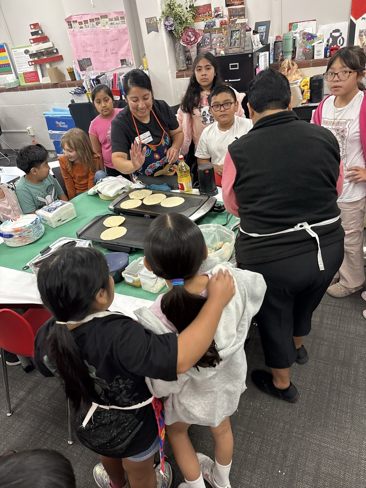 students helping make tortillas