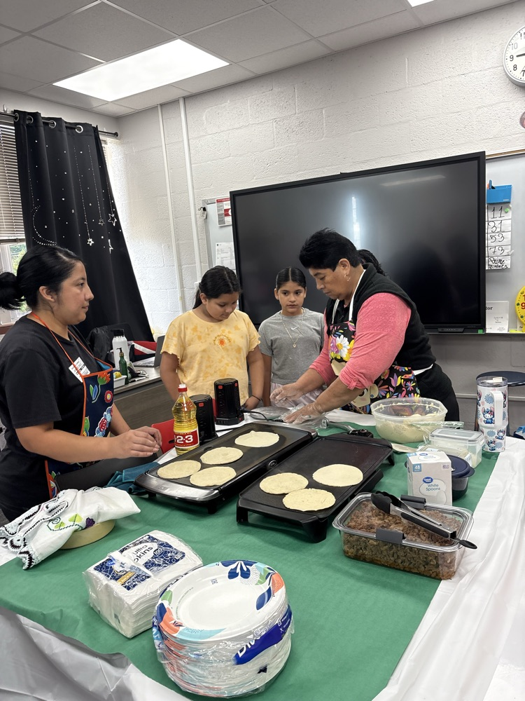 students helping make tortillas