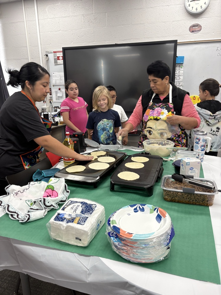 students helping make tortillas