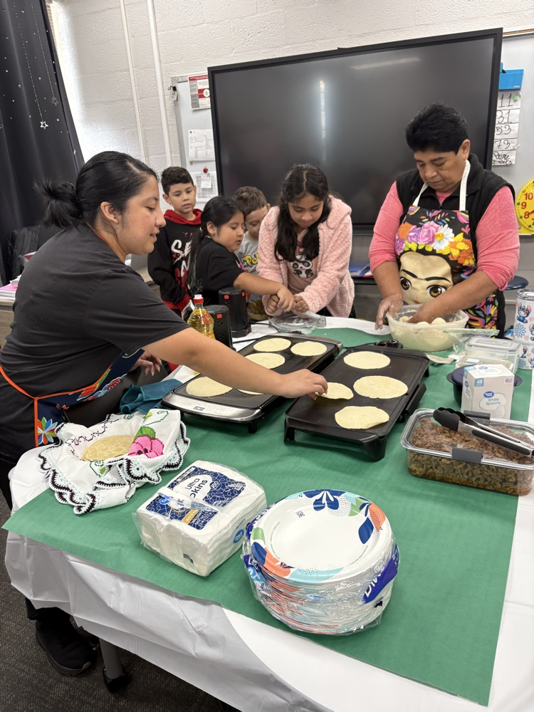 students helping make tortillas