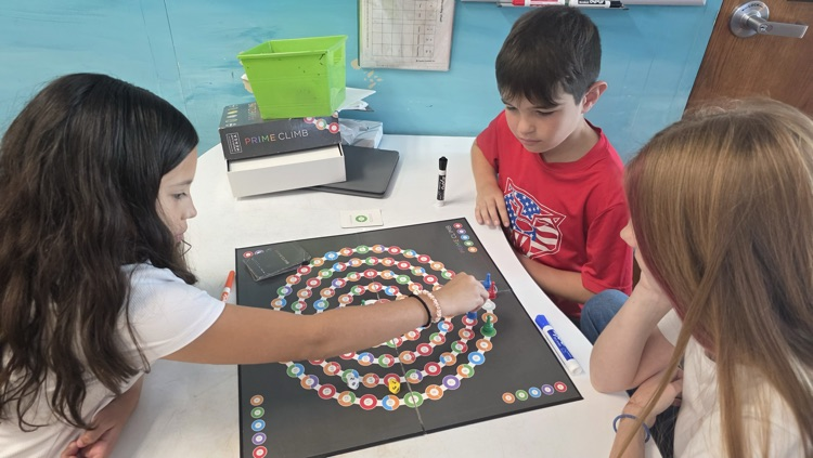 Students playing a game board 