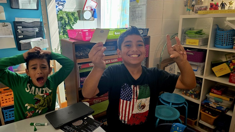 Student celebrating winning the board game 
