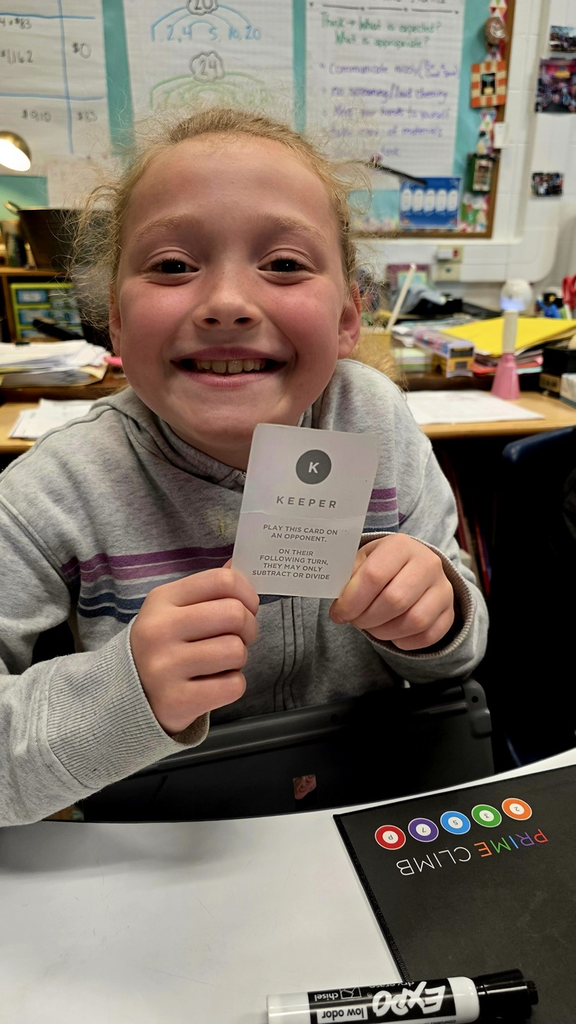 Student holding a game card 