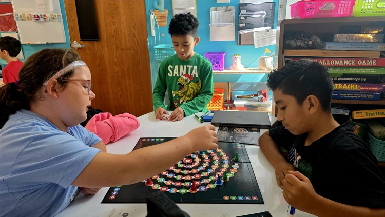 Students playing a board game  
