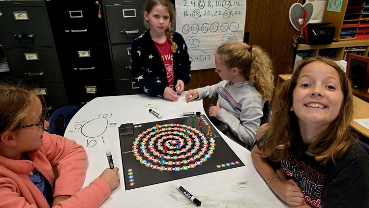Students talking about the board game 