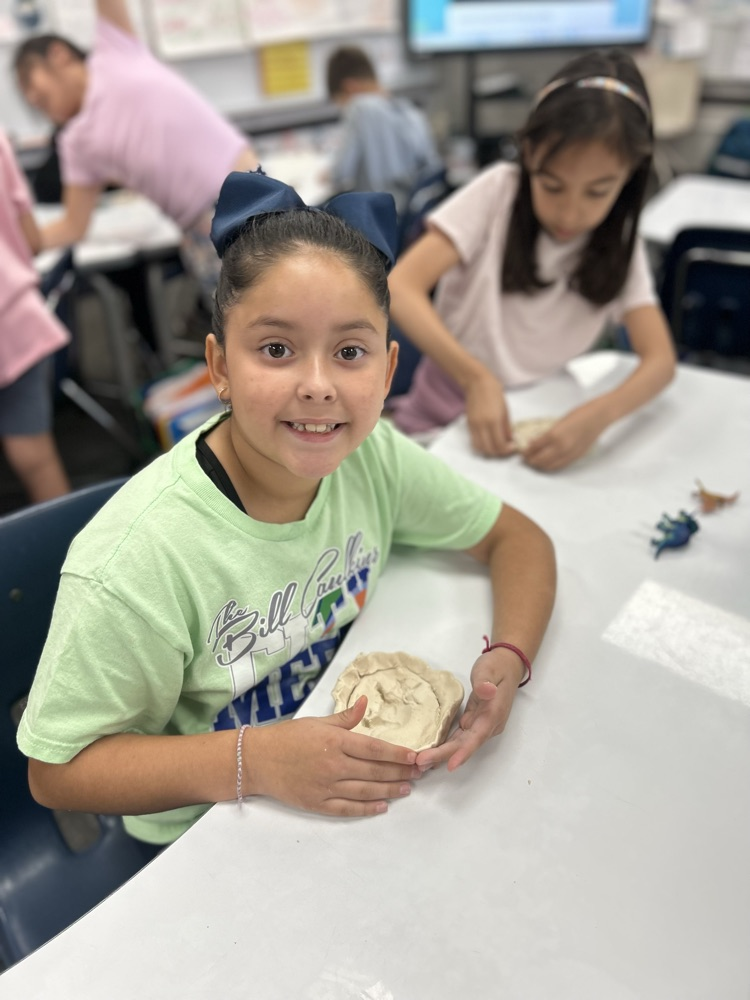 student excavating fossil in classroom