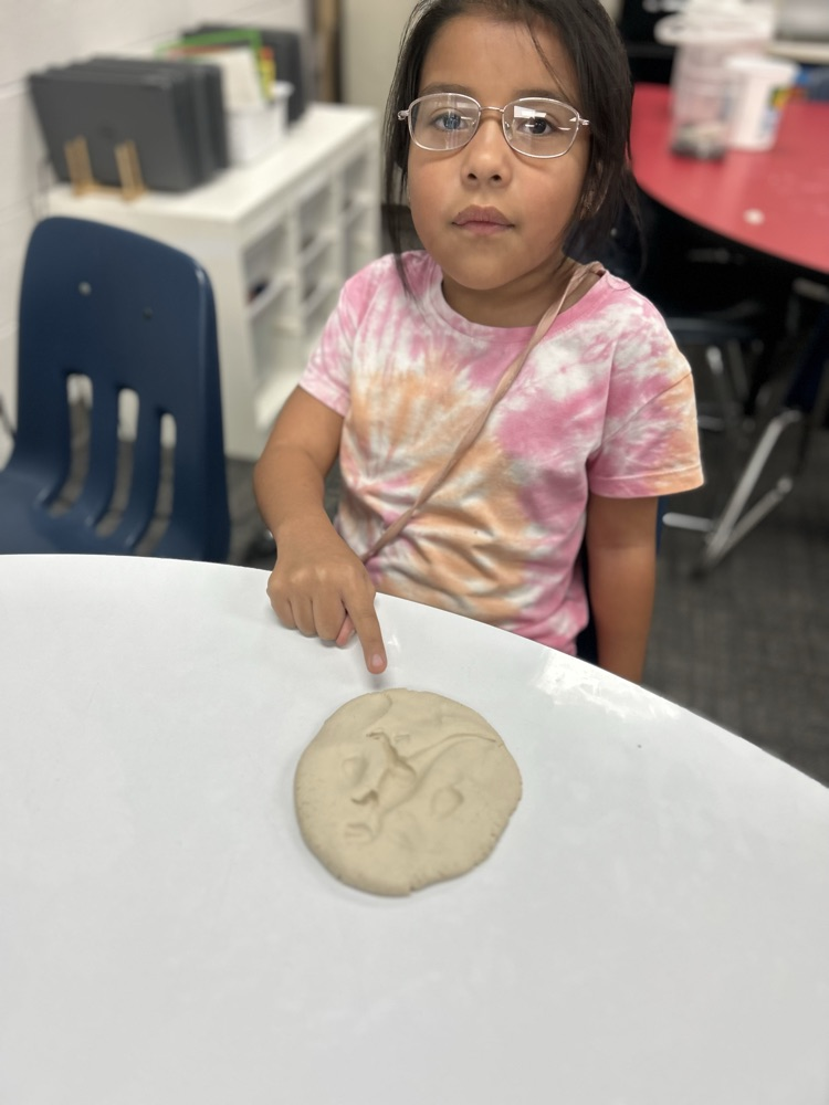 student excavating fossil in classroom