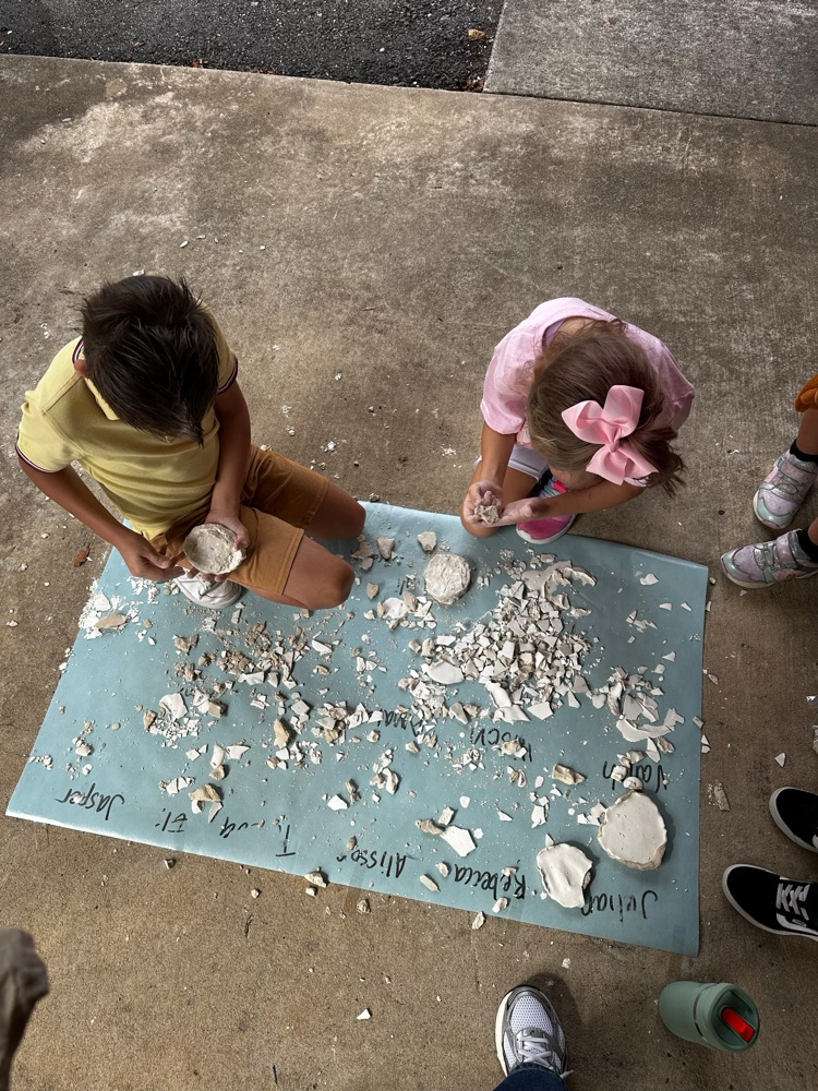 student excavating fossil in classroom