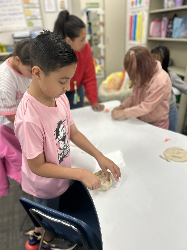student excavating fossil in classroom