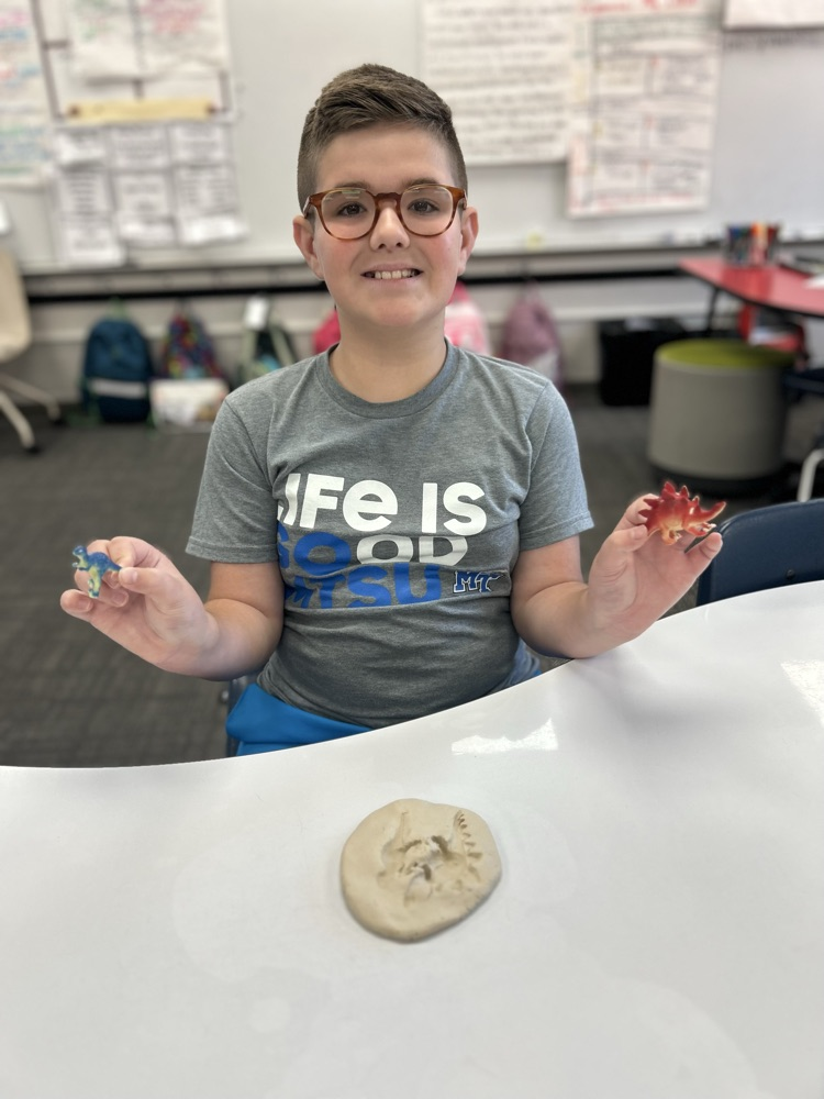 student excavating fossil in classroom