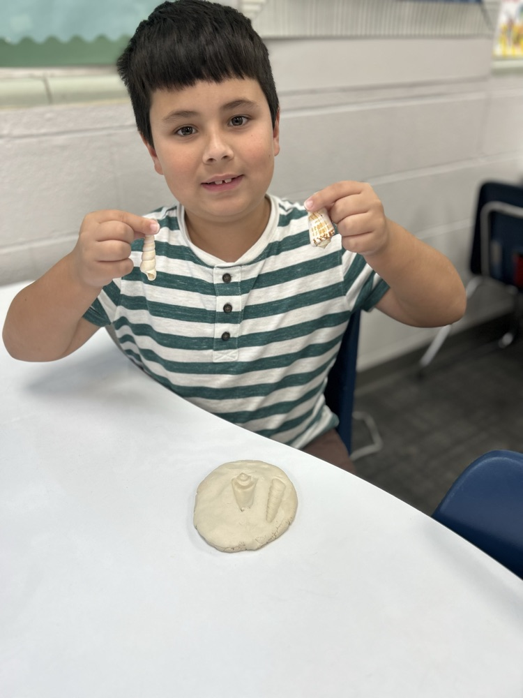 student excavating fossil in classroom