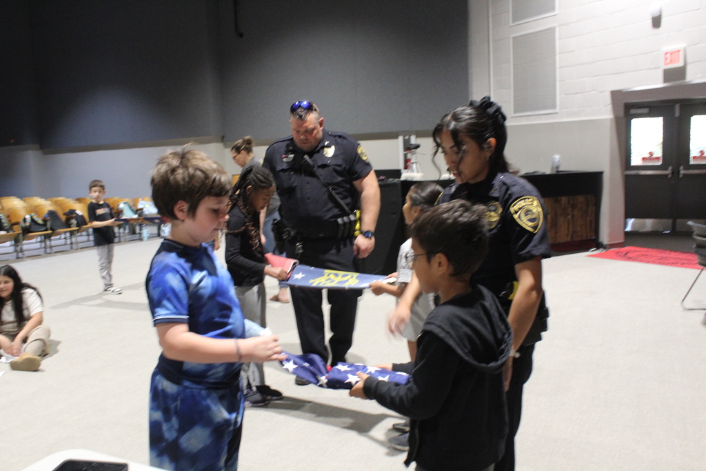 students folding the American flag