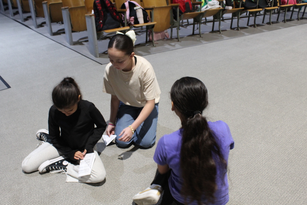 students folding the American flag