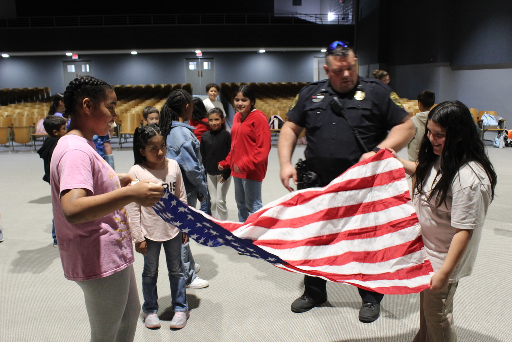 students folding the American flag