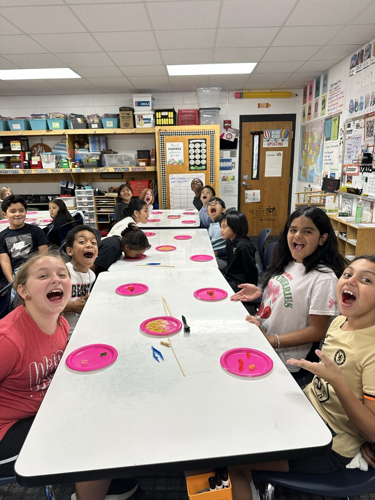 Students showing the food they were able to get in their mouths from their plates without using their hands