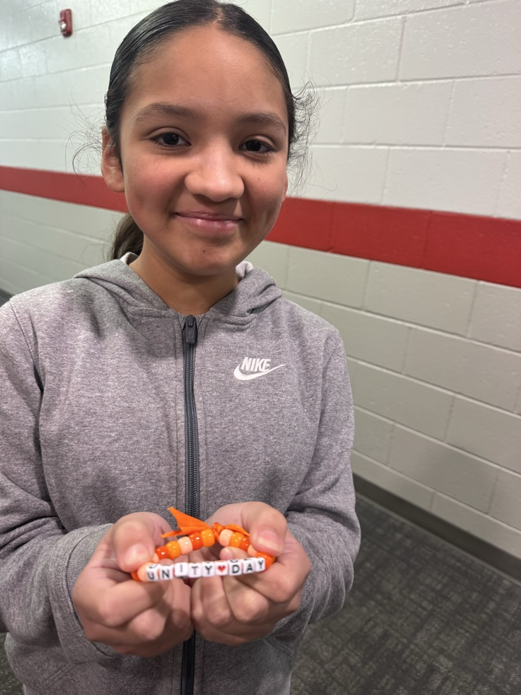student holding bracelet