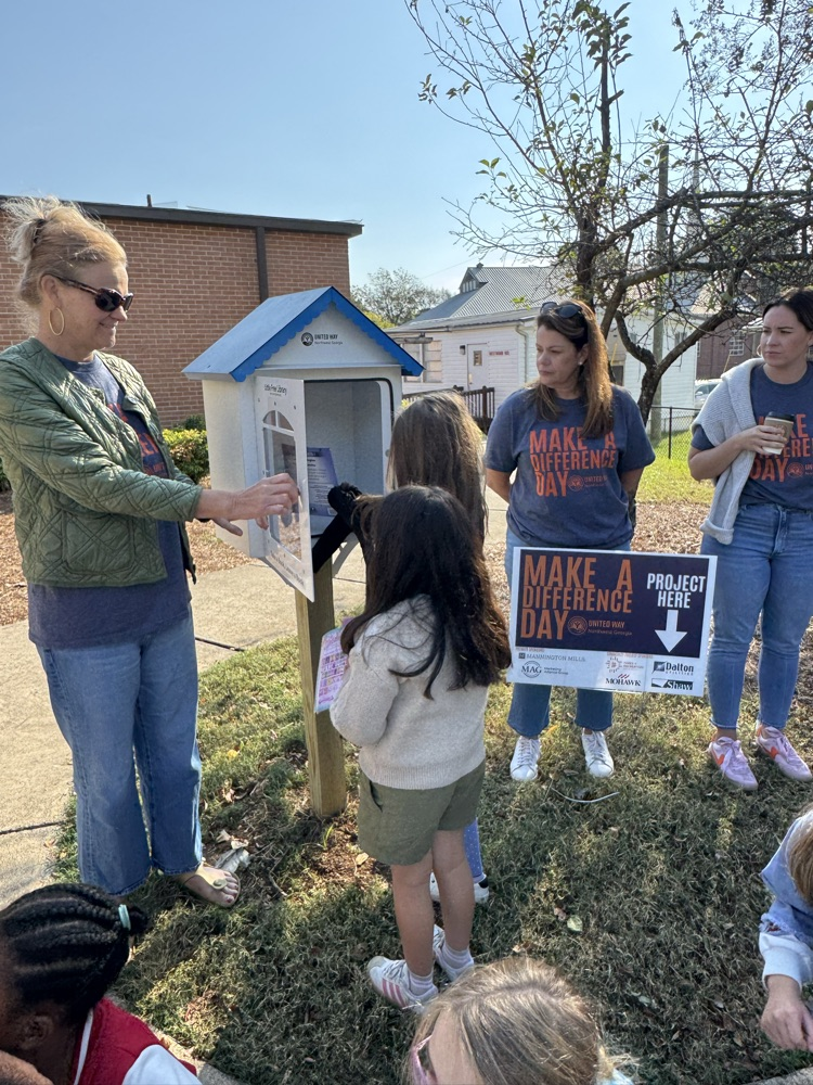 Students putting books in the little library 