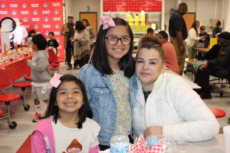 Two students with their grandmother 