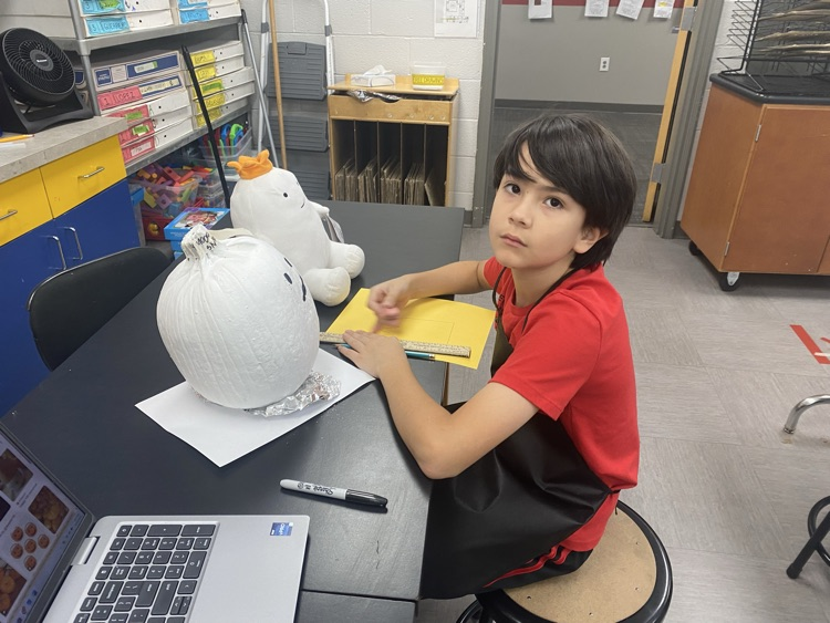 students decorate pumpkins 