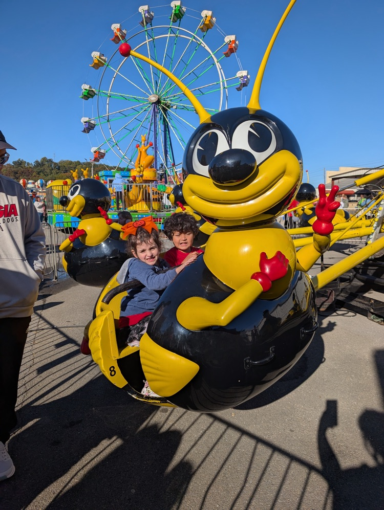 Students riding the bumble bee ride at the fair 