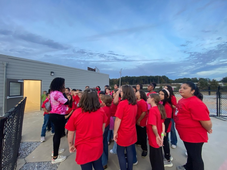 Students listening to instructions before getting on the soccer field 