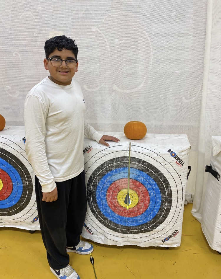 A student showing where the arrow hit 