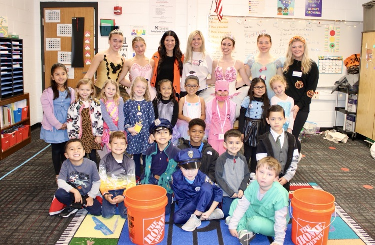Students taking a picture with Nutcracker ballerinas 