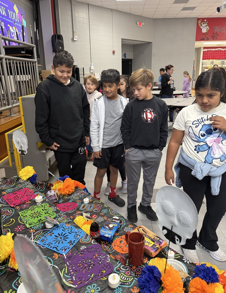 Students looking at the Day of the Dead altar 