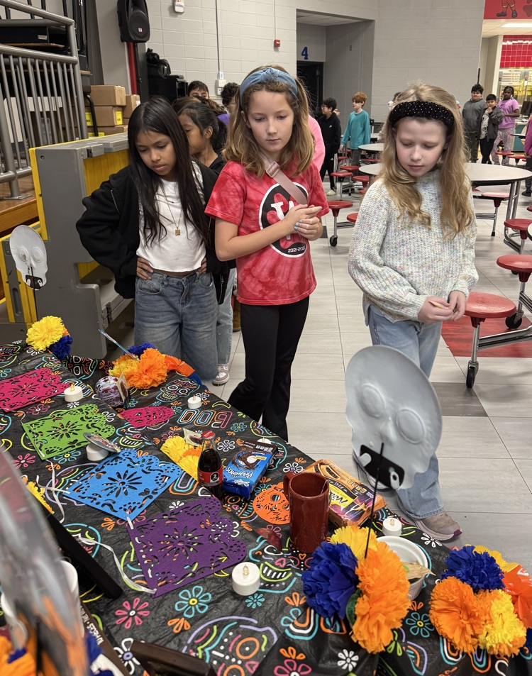 Students looking at the Day of the Dead altar 