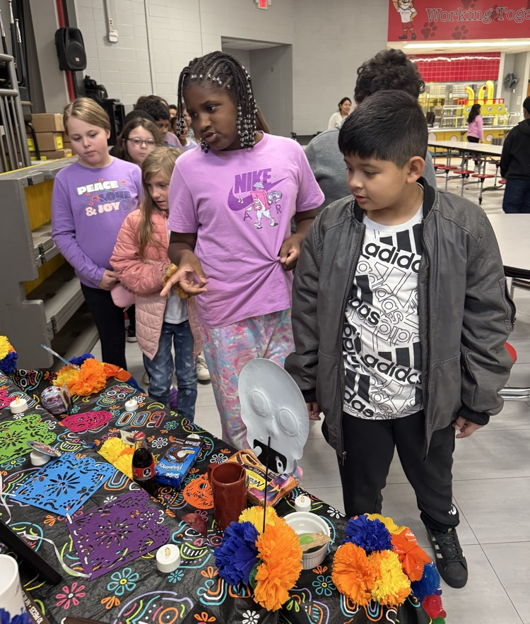 Students looking at the Day of the Dead altar