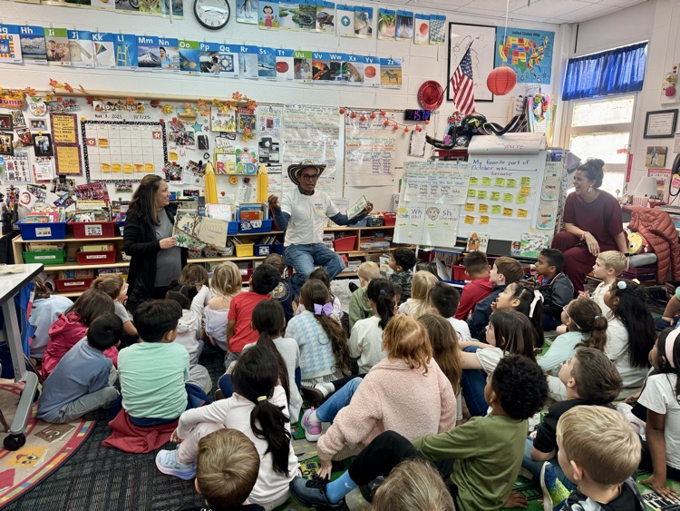 Mr. Soriano talking to first grade students 