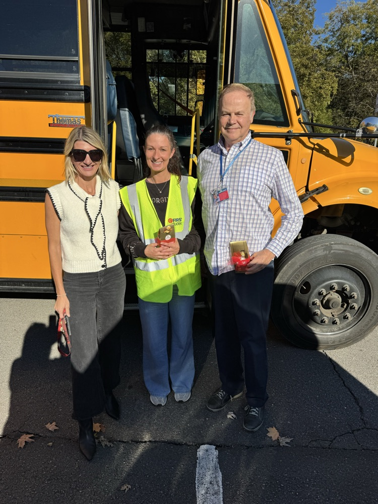 A picture of Mrs. Smith with the bus drivers