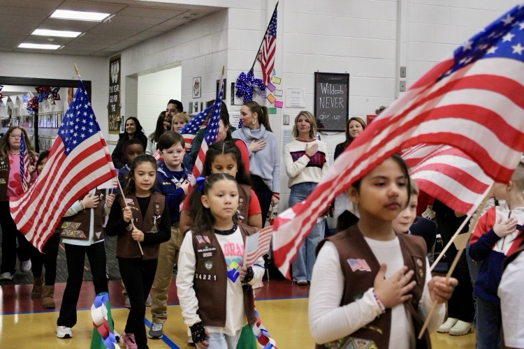 Boys and Girls Scouts carrying the flags 