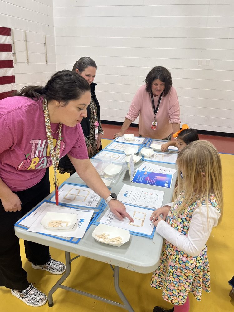 A teacher explaining a math game to a student