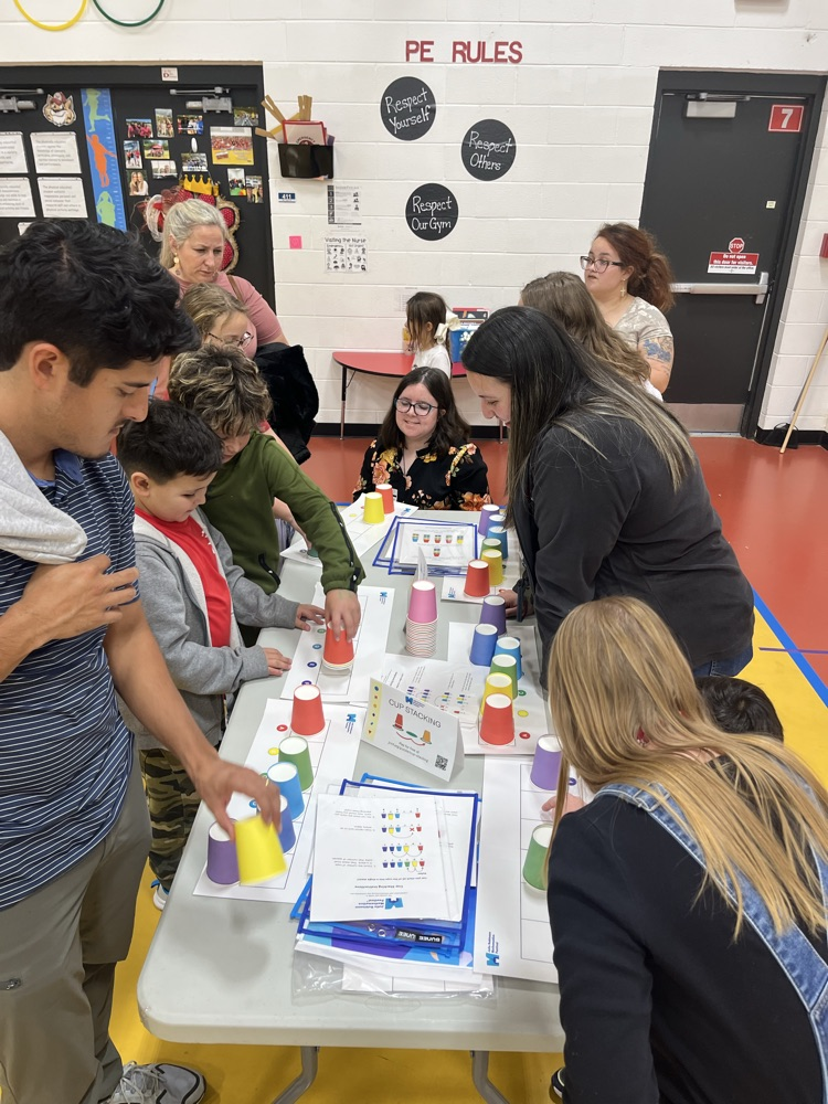 Parents, students and teachers playing a math game