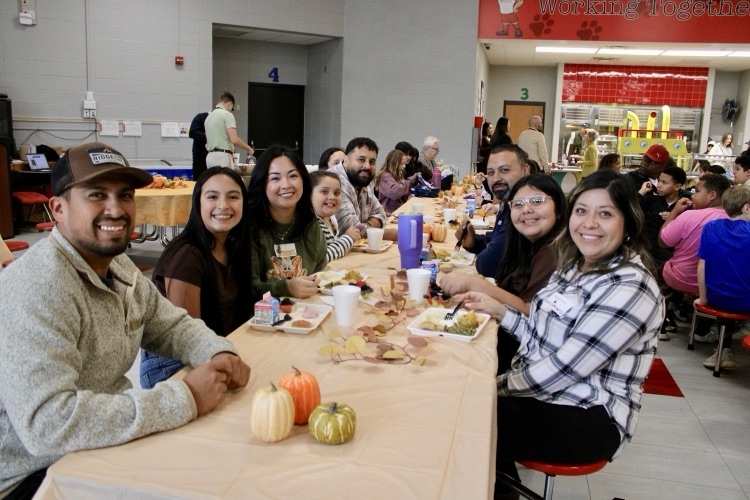 A group of students eating with their families