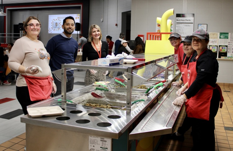 Mrs. Smith helping serving with cafeteria staff