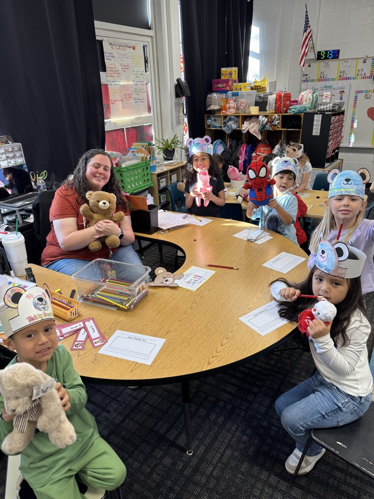 Mrs. Smith and a group of students holding their stuff animals