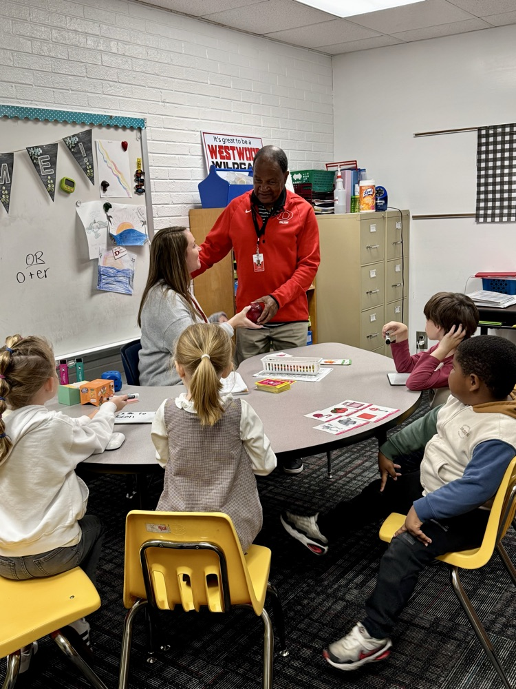Mr. Tulley giving an apple to Mrs. Yarbrough