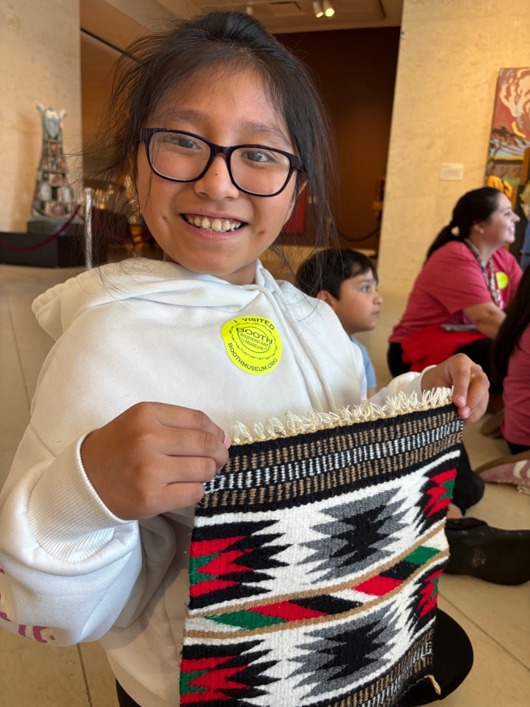 A student holding a small piece of fabric 