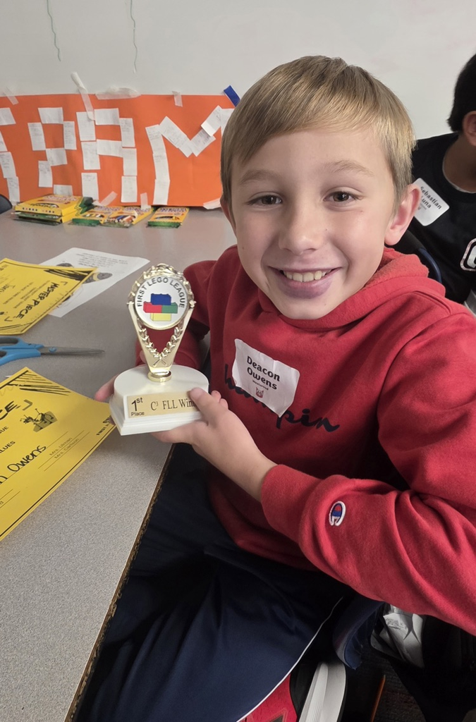 A picture of one of our students holding his trophy 