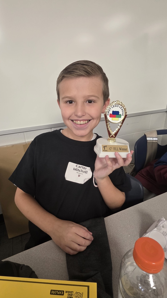 A picture of one of our students showing his trophy