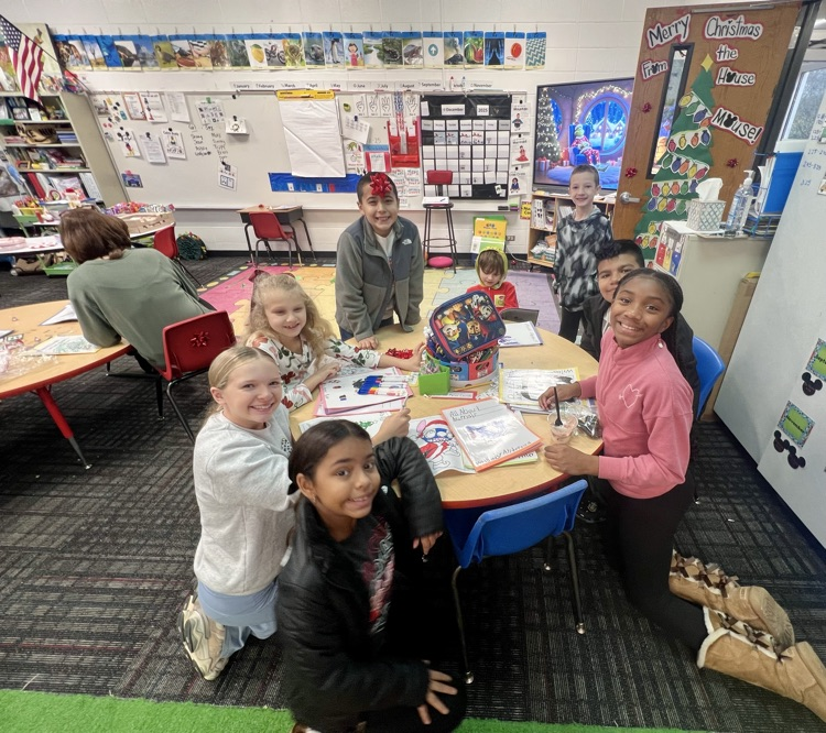 Students with their buddies reading their stories