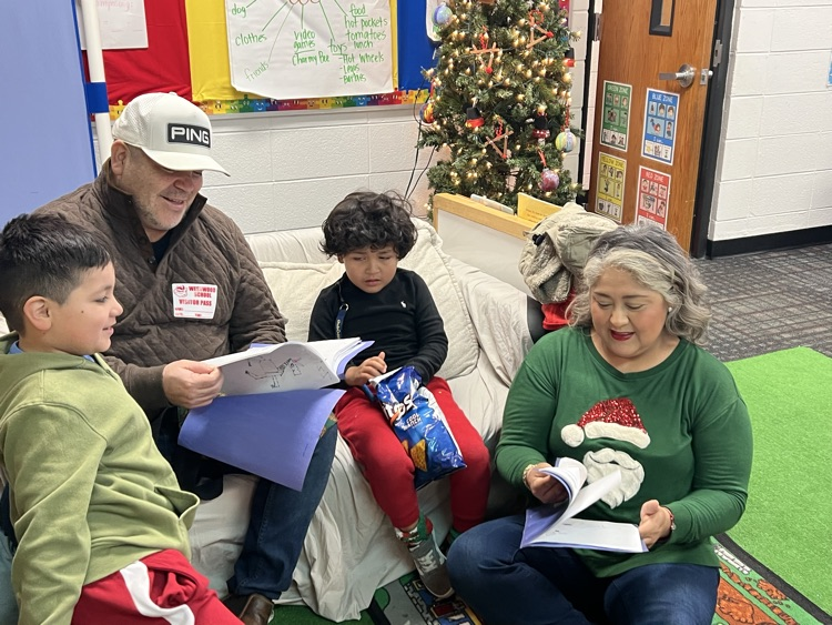 Studevts sharing their writing paper with parents