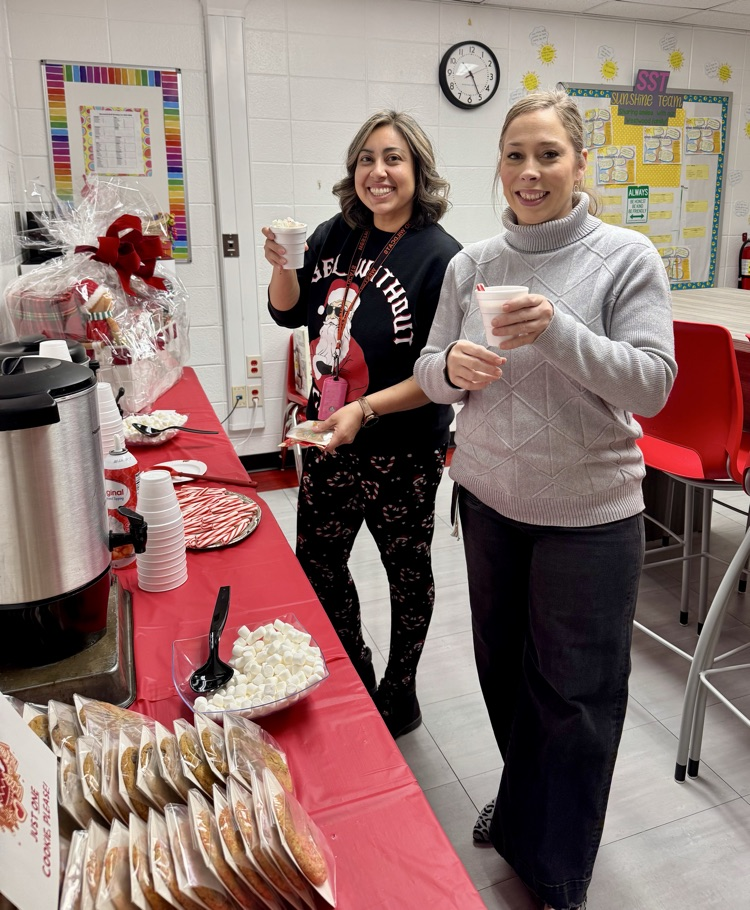 Staff with cocoa and cookies