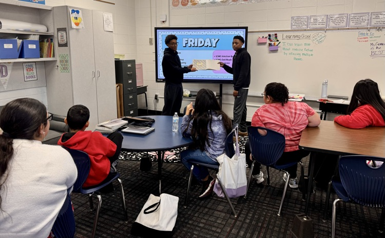 Basketball players reading to Ms.Gomez class