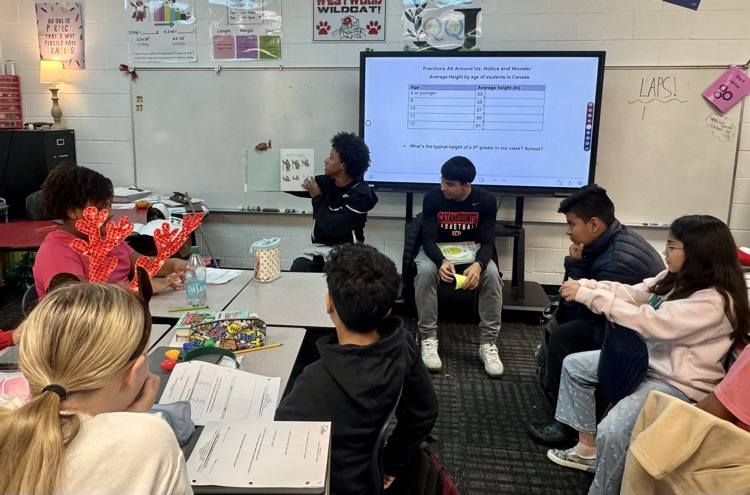 Basketball players reading to a 5th grade class