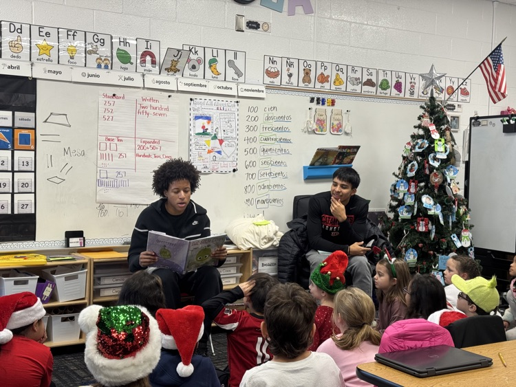 Basketball players reading to a class